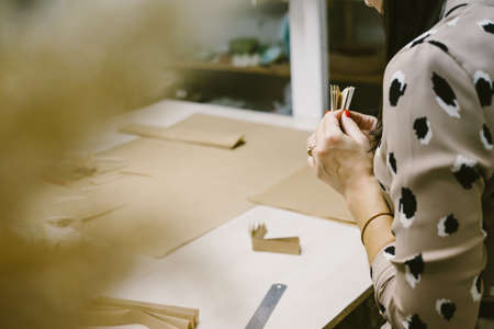 DIY personalized xmas decoration. Creating hand made christmas ornaments. Step by step instructions. Snowflake or three-dimensional star made of kraft paper.の写真素材