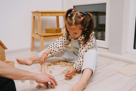 Happy Fathers Day. Playing with my father. Build a tower of wooden cubes.の写真素材