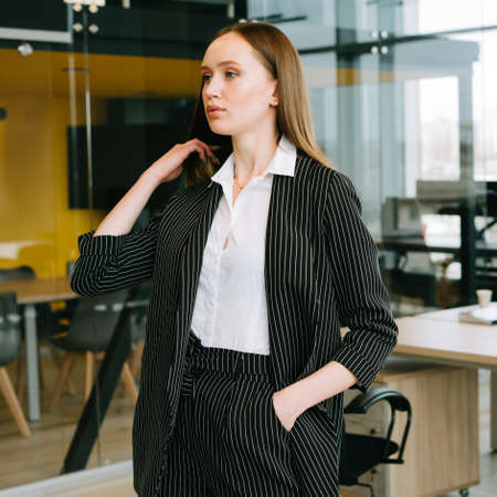 Beautiful business lady in a stylish office. Freelancer. Manager.の写真素材