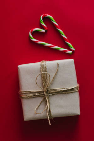 Kraft box tied with rope. Christmas candies in the form of a cane.の写真素材