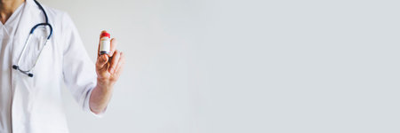 The doctor is holding a tube of medicine in his hand. Vaccine against the virus. A cure for the disease. Vaccine Covid-19. The doctor is on the front line.の写真素材