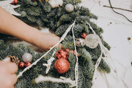 Girls collect a Christmas wreath from natural spruce at the master class. Master class on creating a Christmas wreath with your own hands.の写真素材
