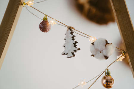 A wooden tree, a cotton box and Christmas balls. Garland is part of the decoration for the action.の写真素材