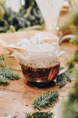 Creation of a Christmas wreath from natural fir and Christmas decorations. Master class on creating a Christmas wreath. made Decor with your own hands. Glass kettle with delicious brewed tea.の写真素材