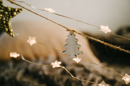 A wooden tree, a cotton box and Christmas balls. Garland is part of the decoration for the action.の写真素材