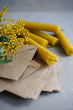 Magic candles. Honey candles for meditation, rituals and purification of space. Branch of yellow mimosa.の写真素材