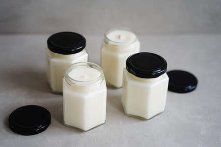 Scented candles in glass containers. Candles made of natural soy wax in glass jars.の写真素材