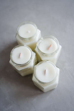 Scented candles in glass containers. Candles made of natural soy wax in glass jars.の写真素材