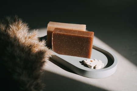 Handmade natural soap and plate. Hard sunlight and hard shadows.の写真素材