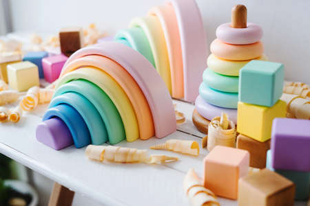 Children's wooden toys. Rainbow made of natural wood. Colorful Cubes and pyramid. Montessori toys. Eco-friendly, plastic free toys for kids. Zero waste concept.の写真素材