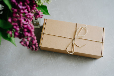 Delivery of goods to the door. Craft box tied with twine on a bow.の写真素材