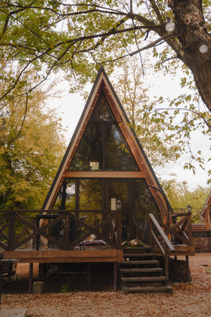 Wooden triangle country tiny cabin house in forest.の写真素材