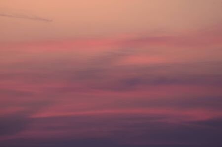 Pink blurred background of sunset cloudy sky