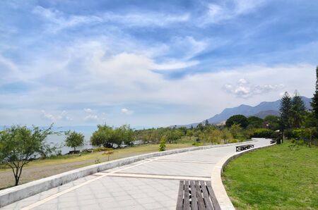 Paved pedestrian road along Chapala lake on a sunny day
