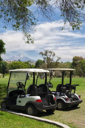 COCOYEC, MEXICO, 27 MARCH 2016: Golf cars at the golf field in front of Popocatepetl volcanoのeditorial素材