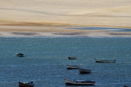 Boats at the coast next to desert