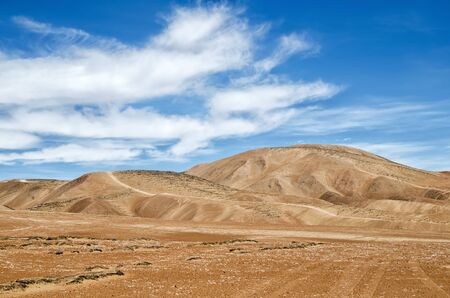 Beautiful desert under blue cloudy skyの写真素材