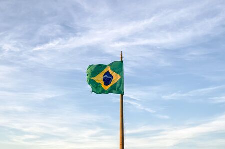 Old Brazilian flag waving on the windの写真素材