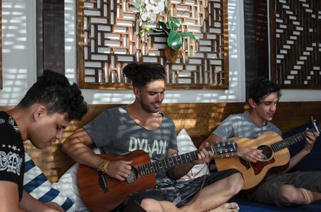 ARRAIAL DO CABO, BRAZIL, 5 SEPTEMBER 2016: three musicians in the creative prosess of writing a songのeditorial素材