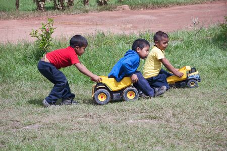 CANAIMA, VENEZUELA, 11 NOVEMBER 2010: Indigenous boys playing with toy trucks outdoorsのeditorial素材
