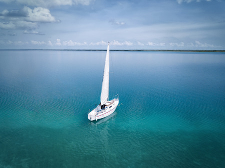 BACALAR, MEXICO, 07 OCTOBER 2017: White sailing boat in the lagoon - shot from droneのeditorial素材