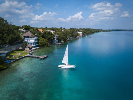 BACALAR, MEXICO, 07 OCTOBER 2017: aerial view to the shore with hotels, beaches and white sailing...