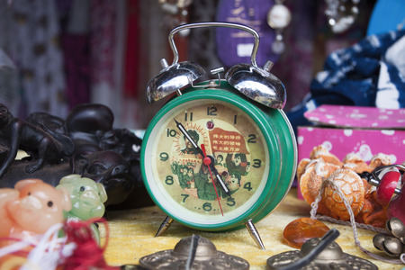 DALI, CHINA, 2011-09-13: old mechanic alarm clock featuring Mao and Chinese communist movement in it...