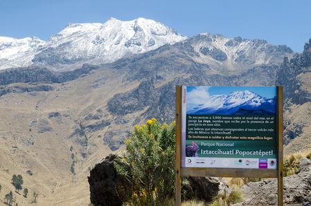Iztaccihuatl Popocatepetl National Park, Mexico, 2018-04-20: sign of national park at the entrance to the hiking routs in mountains with the view to snowy peak of Iztaccihuatl volcanoのeditorial素材