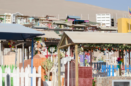 ARICA, CHILE, 2017-01-25: colorful cemetery in the desert - closeup featuring some of the gravesのeditorial素材