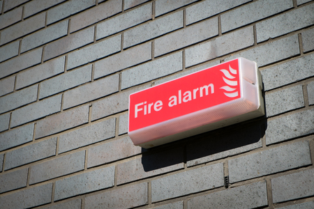 Fire alarm sign on the wallの写真素材