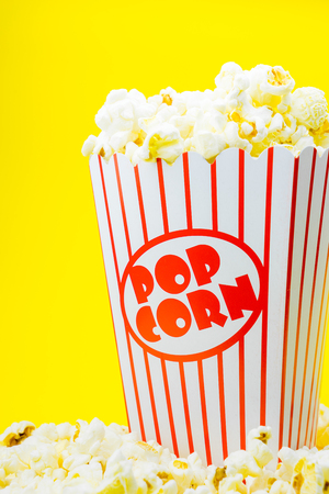 Classic box cinema popcorn on yellow backgroundの写真素材