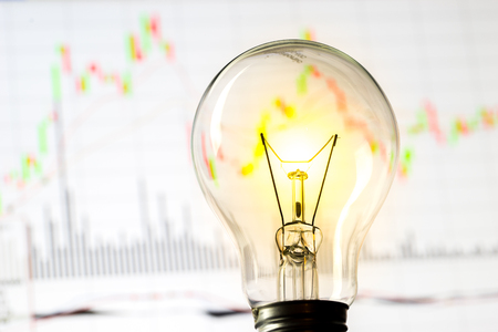 Business success with stock graph and light bulbの写真素材