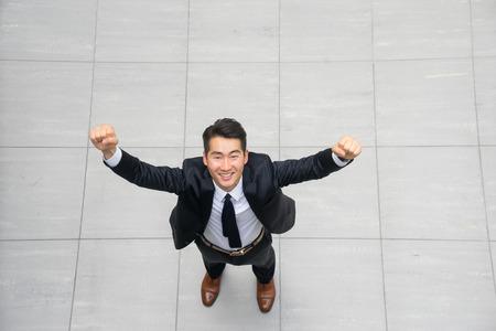 Young asian businessman using tablet, mobile phone in the officeの写真素材