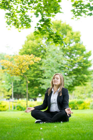 Businesswoman meditating and Yoga in a parkの写真素材