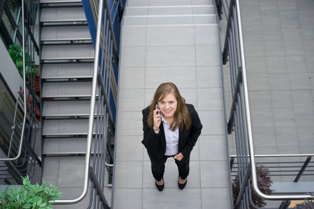 Businesswoman working & sitting at her desk in an officeの写真素材