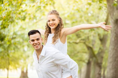 Young couple walking, Hyde Park, London: sunset colour toneの写真素材