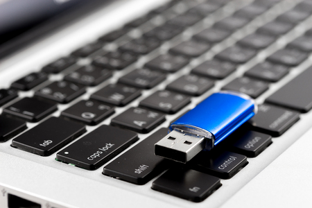 USB Flash drive on computer laptop keyboard