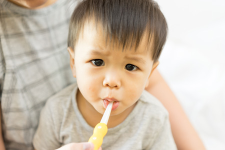 Asian baby uses toothbrushの写真素材