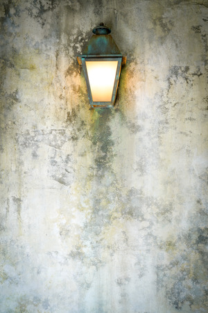 Rough cement wall texture background with a lampの写真素材