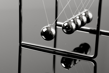 Newtons Cradle balancing balls, business concept in studioの写真素材