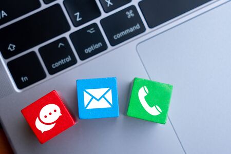 Contact us icon on colorful puzzle with handの写真素材