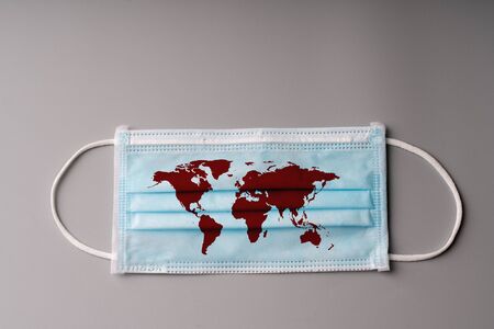 The surgery mask with world map icon for epidemic concept & COVID 19 virusの写真素材
