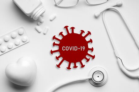 COVID 19 or Corona virus icon on top view of medical equipmentの写真素材