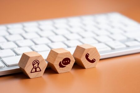 Contact us icon on wood puzzleの写真素材