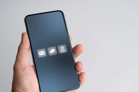Contact us business icon on smart phoneの写真素材