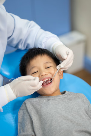 Asian kid check up with dentist at the dental clinic. Concept of dental check up and healthcareの写真素材