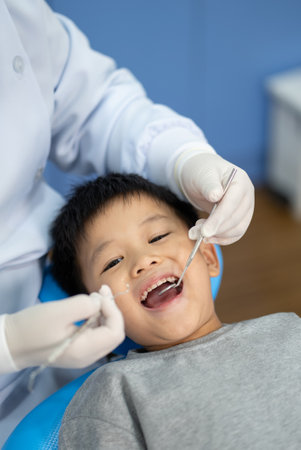Asian kid check up with dentist at the dental clinic. Concept of dental check up and healthcareの写真素材