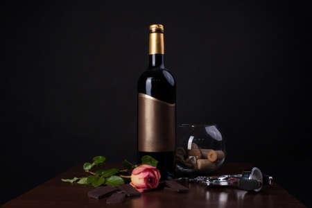 A bottle of wine and chocolate on the tableの写真素材