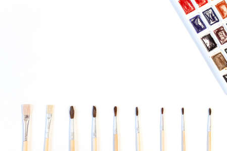 Watercolor paints and brushes isolated