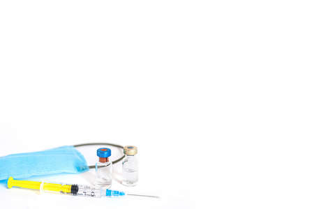 Syringe with vaccine and ampule and medical face maskの写真素材